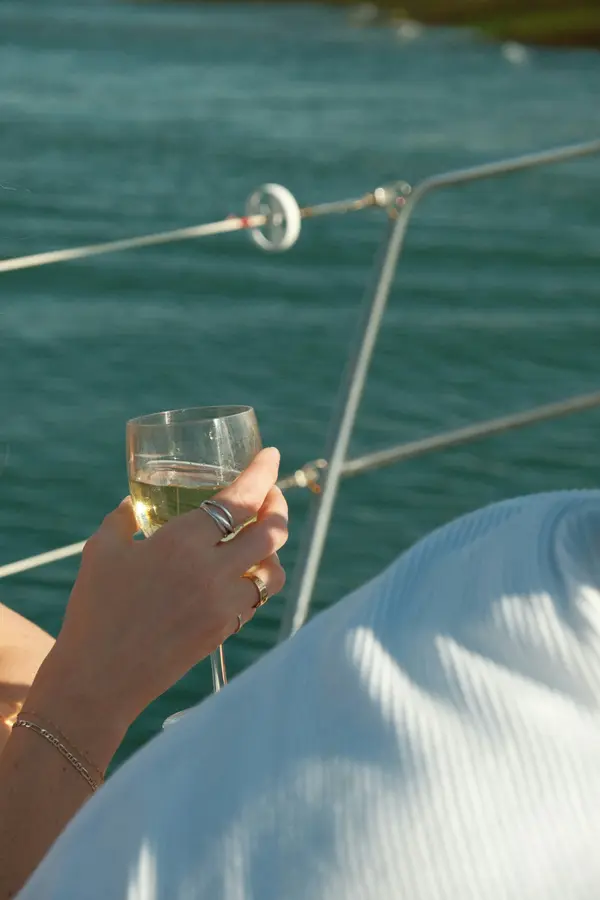 Um copo de vinho no convés durante um passeio de barco privado em Lisboa